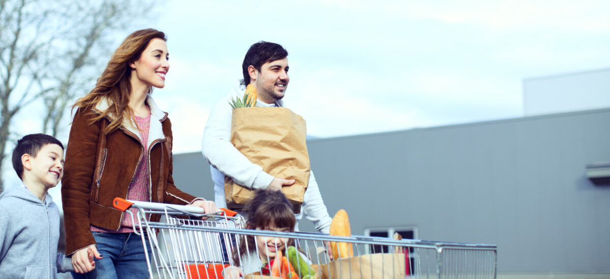 A family shops at a local grocery store within walking distance from their home.